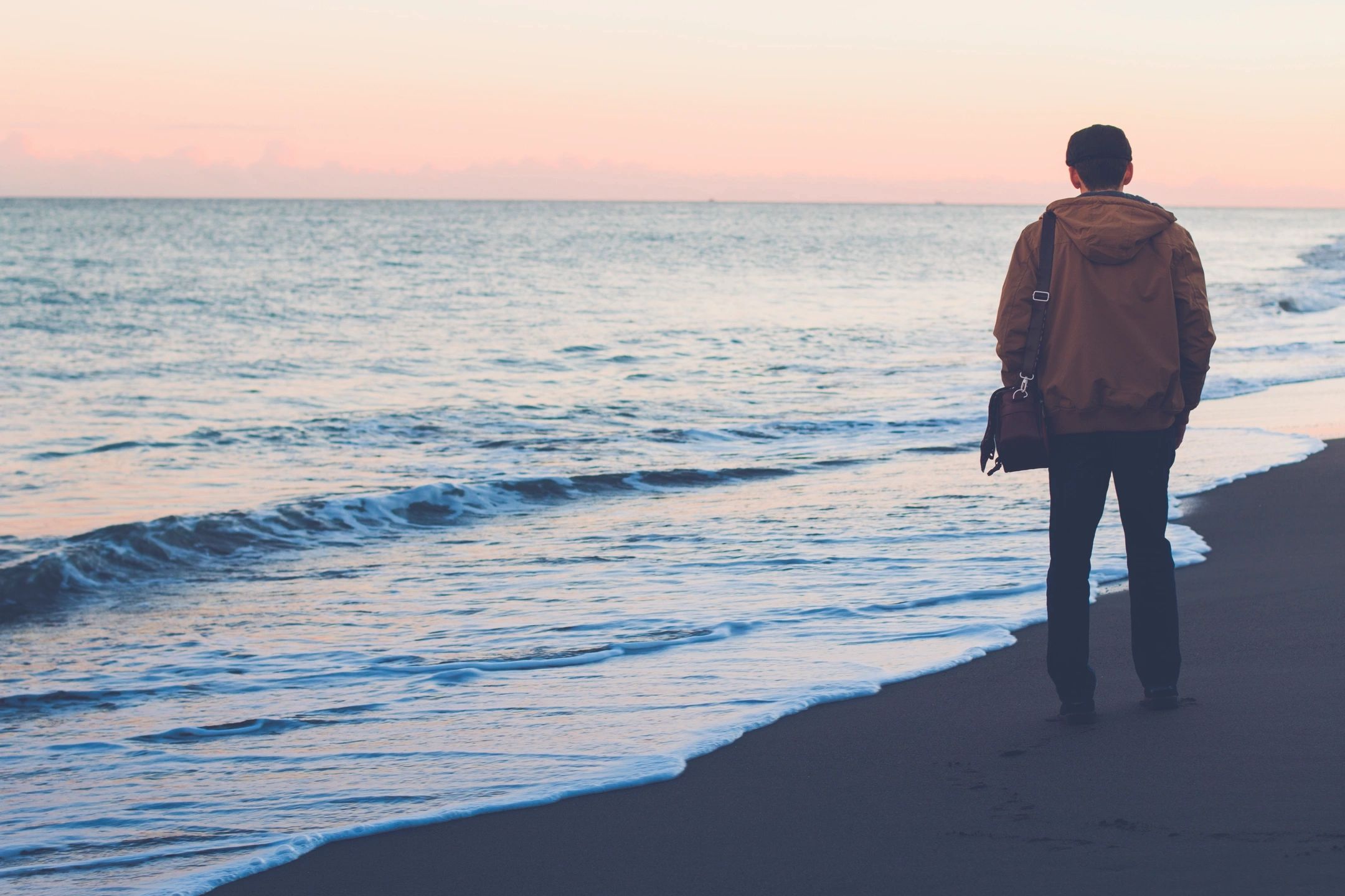 a man walking on the beach